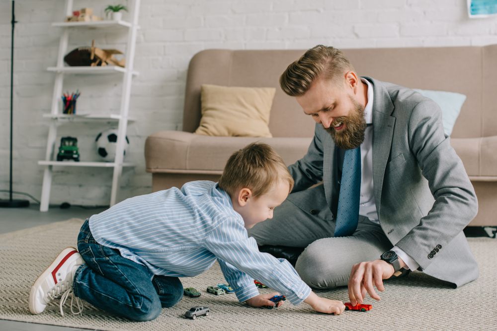 Businessman,In,Suit,And,Little,Son,Playing,With,Toy,Cars