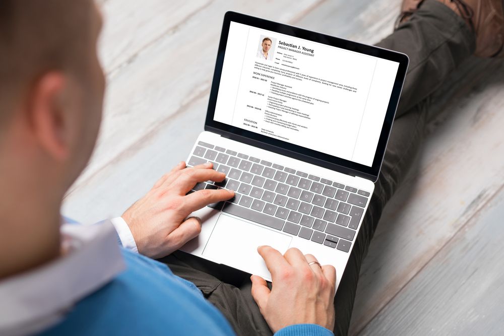 Man,Creating,His,Cv,On,Laptop.,All,Contents,In,Document