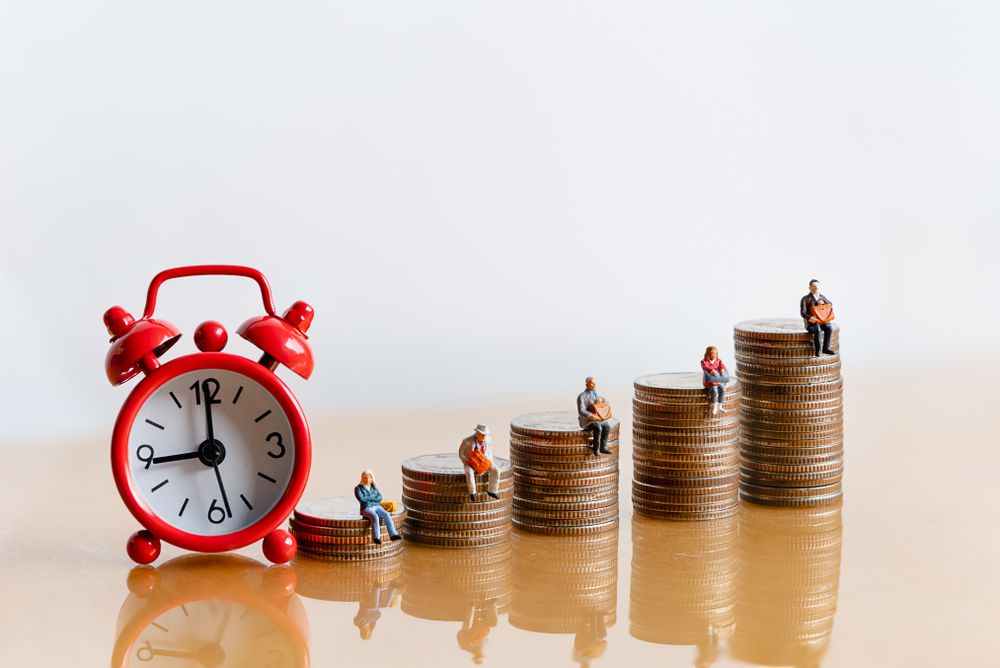 Miniature,People:,Red,Alarm,Clock,And,Elderly,People,Sitting,On